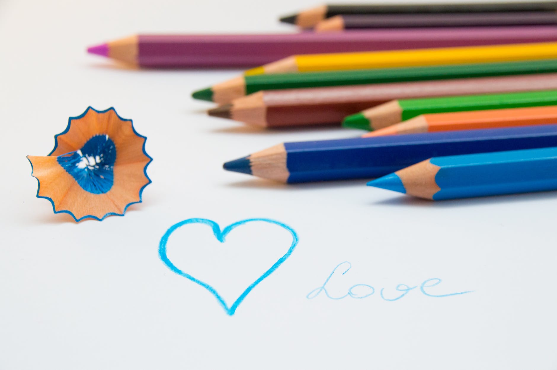 Pencils with shaving and drawing of a heart in blue